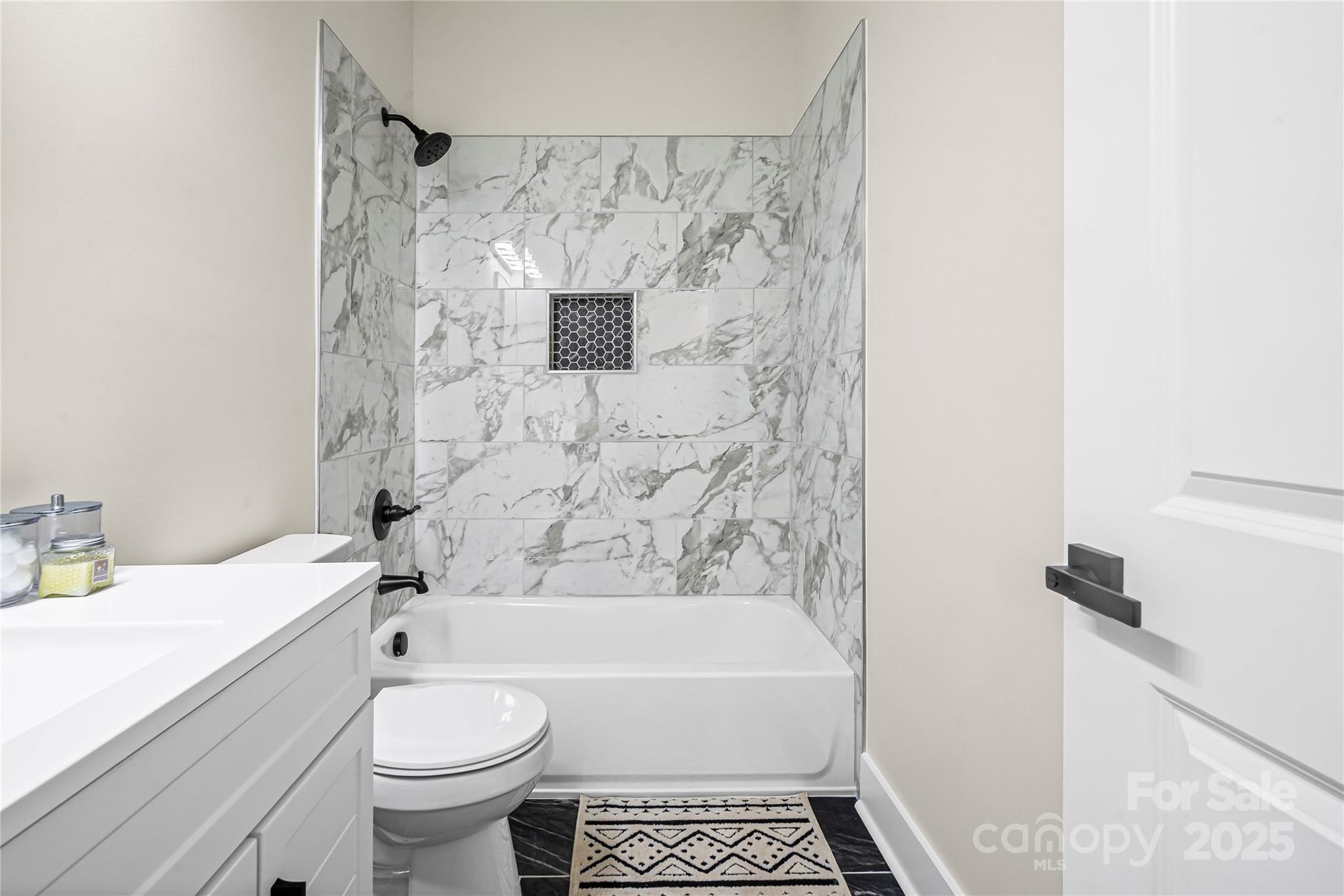 241 Booker Drive Southwest Concord, NC 28025 - Photo 18 of 29 a bathroom with a toilet sink and bathtub