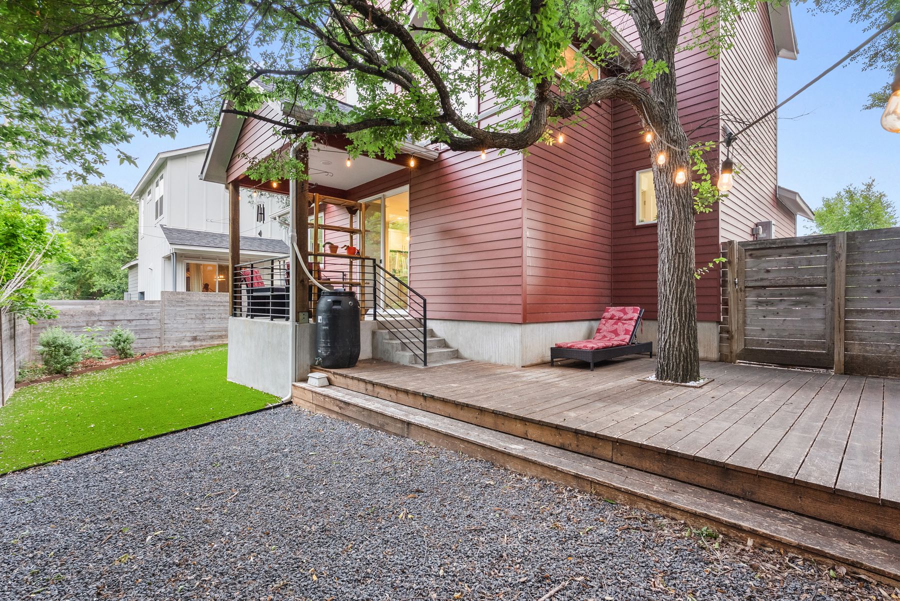 1709 Perez Street, Unit 2 Austin, TX 78721 - Photo 30 of 33 A spacious wooden deck with string lights provides an inviting outdoor entertaining area.