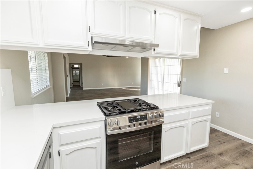 28702 Rancho Avenue Madera, CA 93638 - Photo 12 of 34 a kitchen with granite countertop white cabinets and white appliances