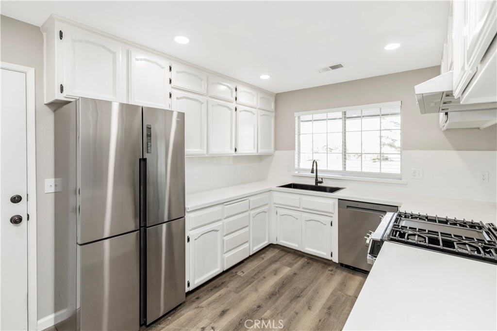 28702 Rancho Avenue Madera, CA 93638 - Photo 13 of 34 a kitchen with stainless steel appliances a refrigerator a sink a stove a microwave and cabinets