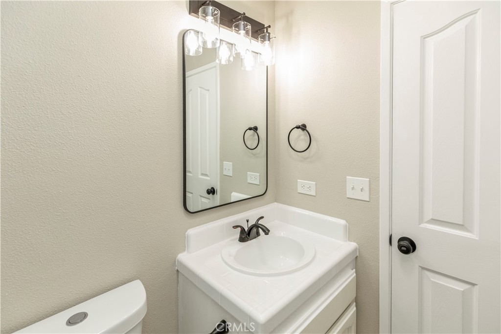 28702 Rancho Avenue Madera, CA 93638 - Photo 21 of 34 a bathroom with a sink a toilet and shower