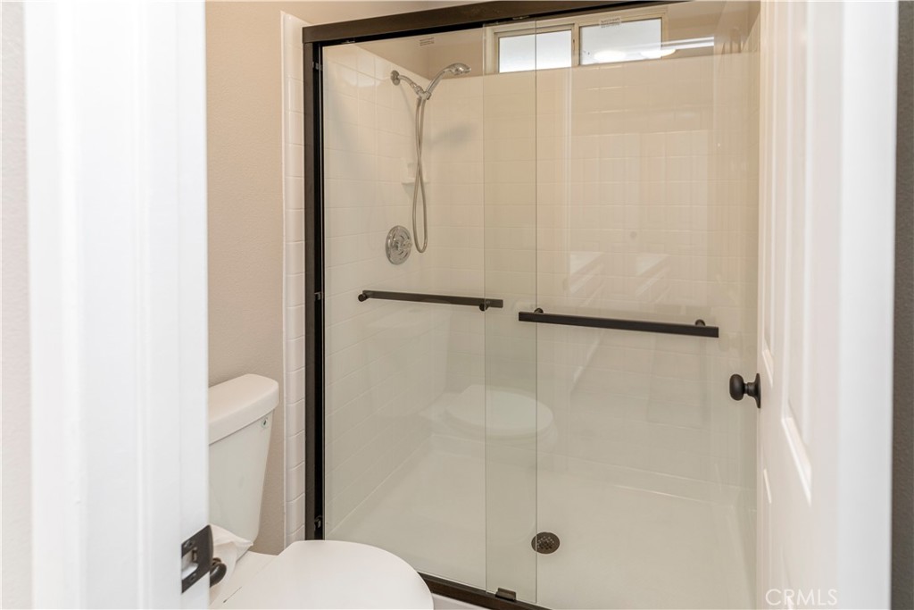 28702 Rancho Avenue Madera, CA 93638 - Photo 23 of 34 a bathroom with a shower and a toilet