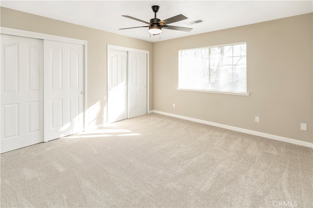 28702 Rancho Avenue Madera, CA 93638 - Photo 24 of 34 an empty room with windows and fan