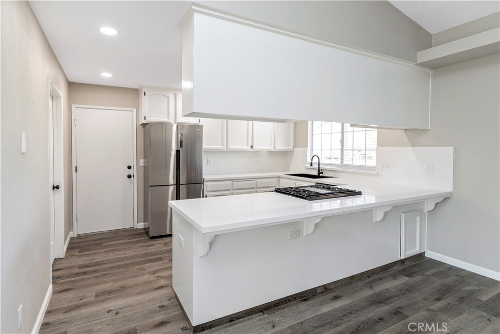 28702 Rancho Avenue Madera, CA 93638 - Photo 9 of 34 a kitchen with stainless steel appliances a sink stove and refrigerator