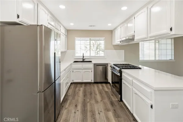 a kitchen with granite countertop a stove and a sink