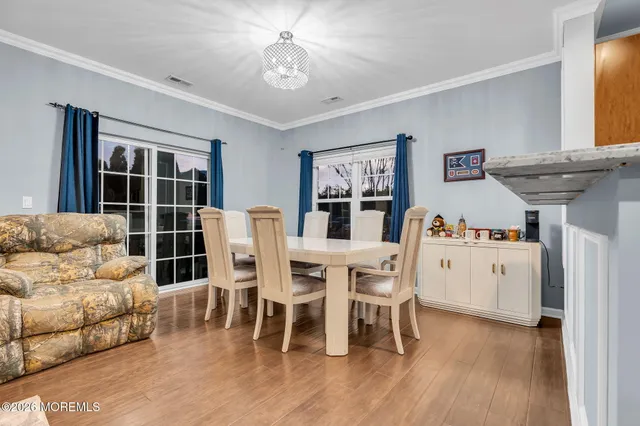 a view of a dining room with furniture and wooden floor