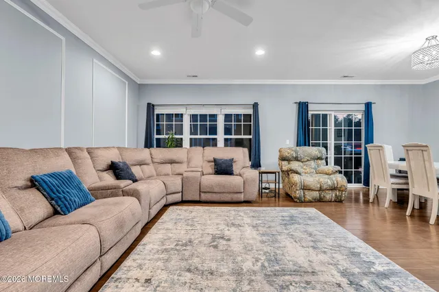 a living room with furniture and wooden floor
