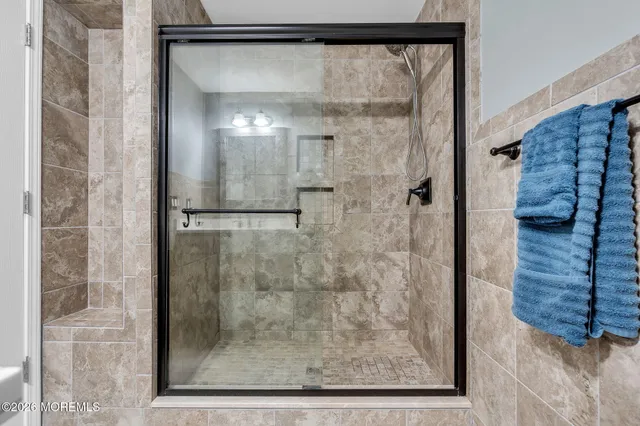 a bathroom with a glass shower door