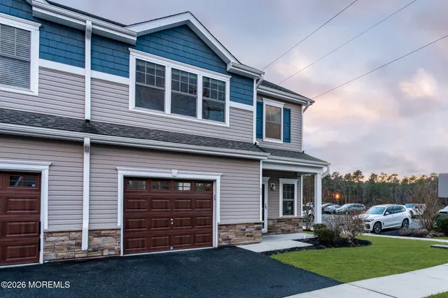 a view of a house with a yard and lawn chairs