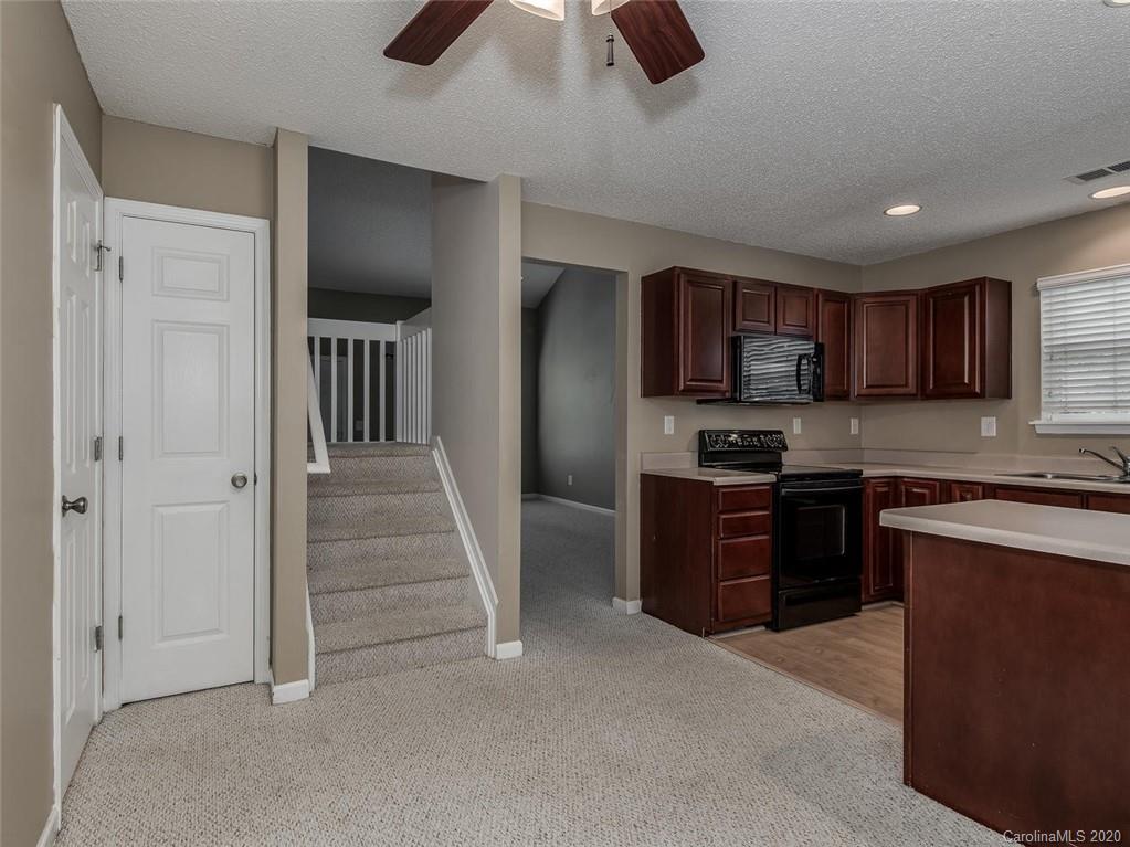 8376 Rudolph Road Charlotte, NC 28216 - Photo 11 of 17 a kitchen with stainless steel appliances granite countertop a refrigerator and a sink