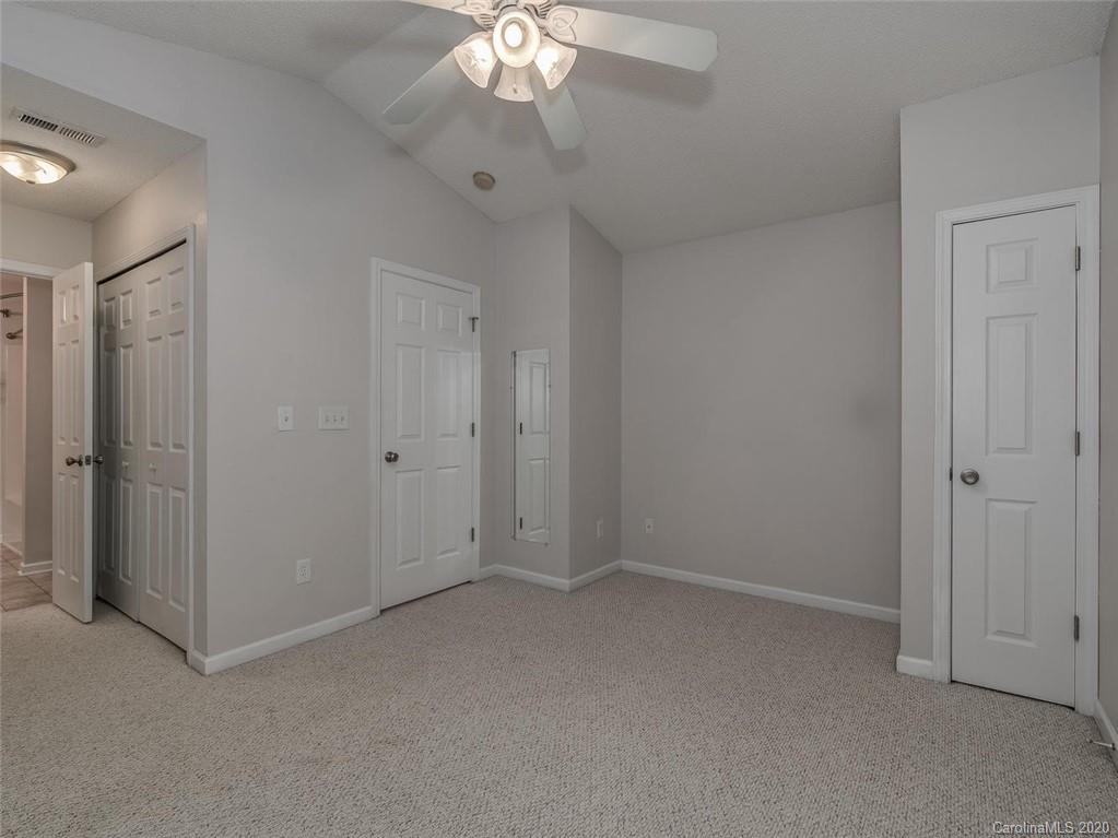 8376 Rudolph Road Charlotte, NC 28216 - Photo 12 of 17 an empty room with a chandelier fan