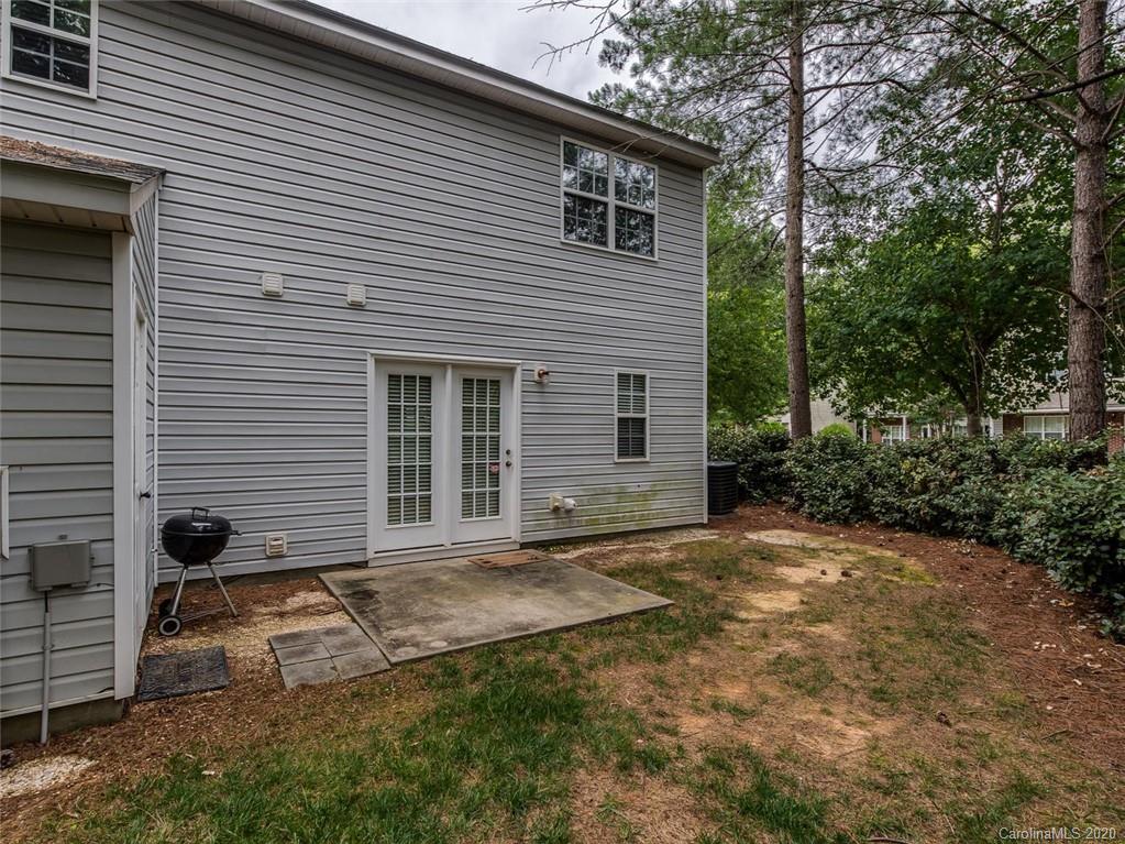 8376 Rudolph Road Charlotte, NC 28216 - Photo 16 of 17 a view of a house with backyard and a tree