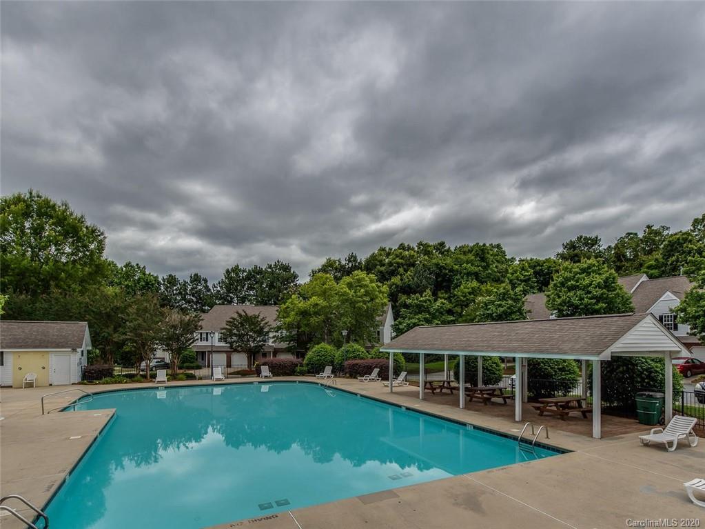 8376 Rudolph Road Charlotte, NC 28216 - Photo 17 of 17 an aerial view of a house with swimming pool patio and lake view