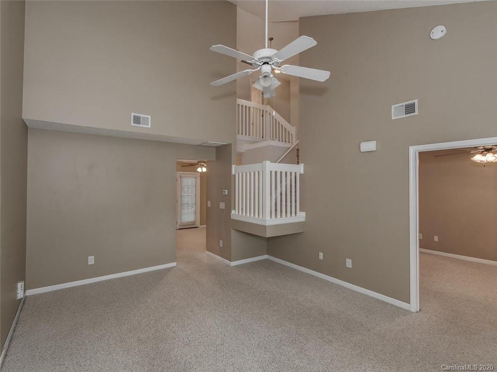 8376 Rudolph Road Charlotte, NC 28216 - Photo 4 of 17 en empty room with windows and fan