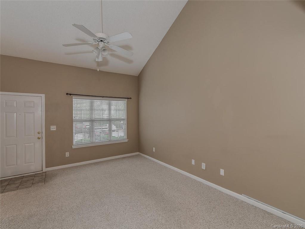 8376 Rudolph Road Charlotte, NC 28216 - Photo 5 of 17 an empty room with a window and a fan