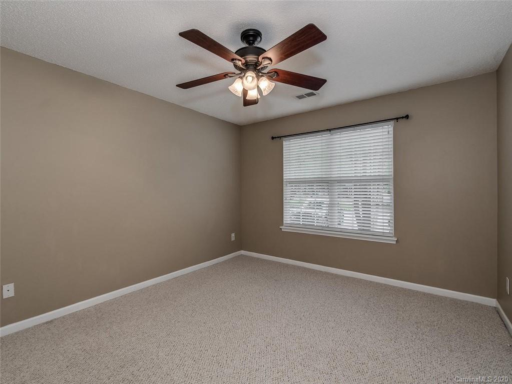 8376 Rudolph Road Charlotte, NC 28216 - Photo 6 of 17 an empty room with window and ceiling fan