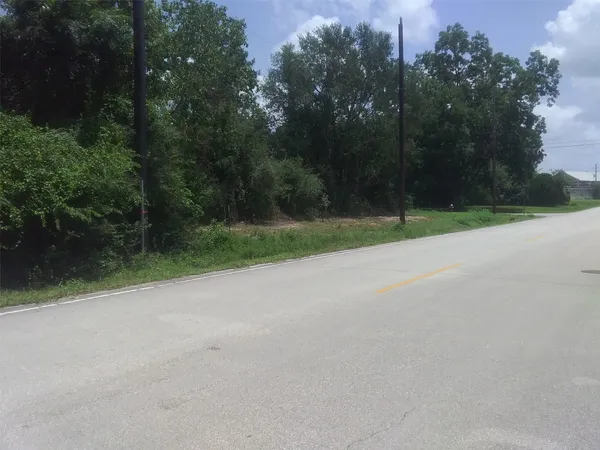 a view of a field with trees in background