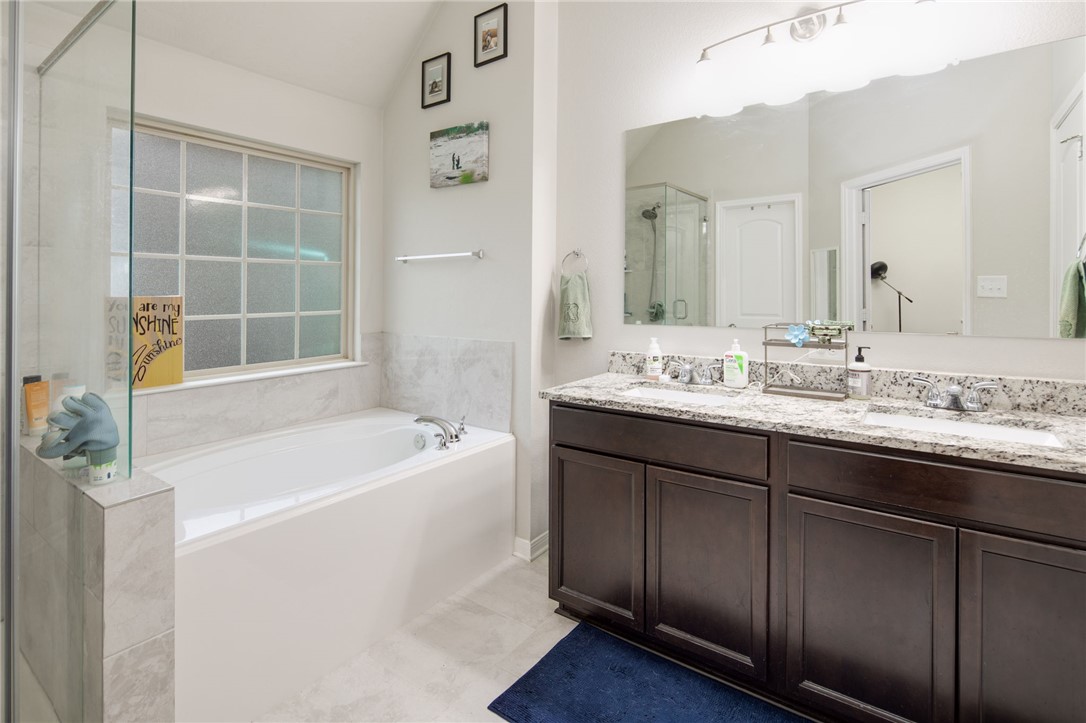 2120 Markley Drive Bryan, TX 77807 - Photo 12 of 21 a bathroom with a tub sink and mirror