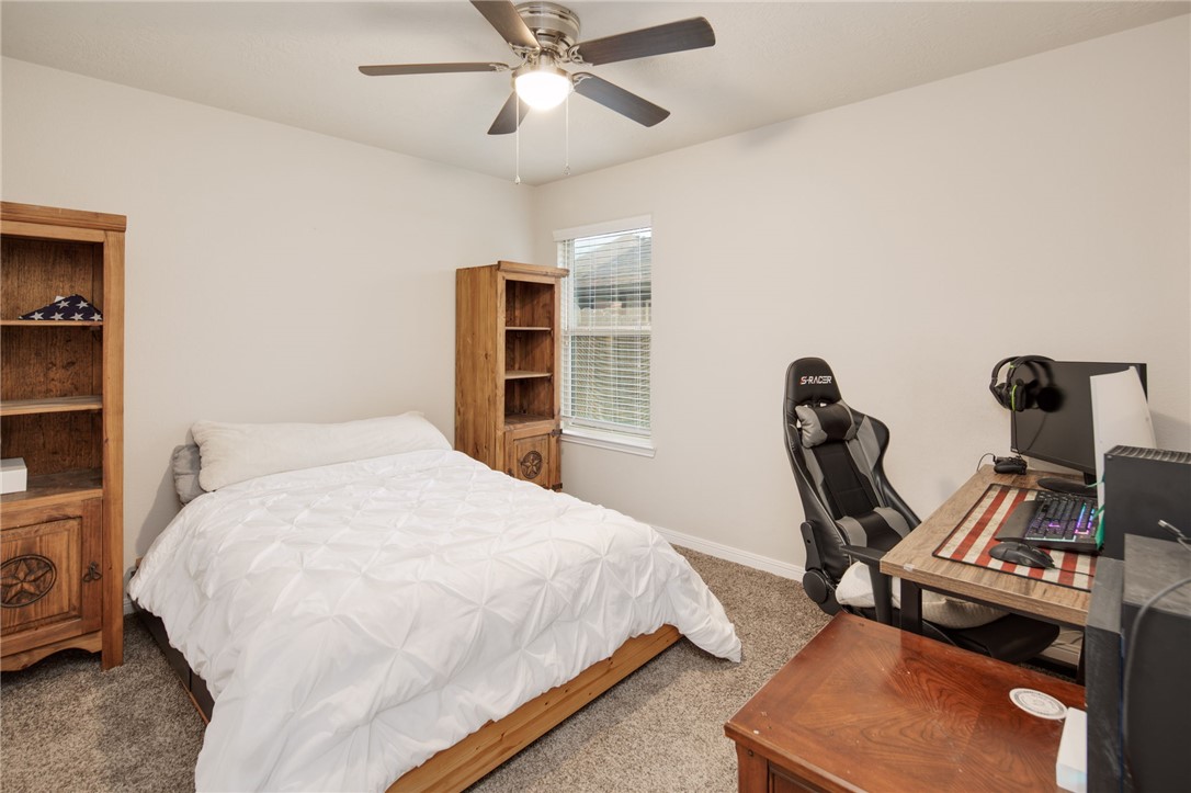 2120 Markley Drive Bryan, TX 77807 - Photo 14 of 21 a bedroom with a bed and a chandelier