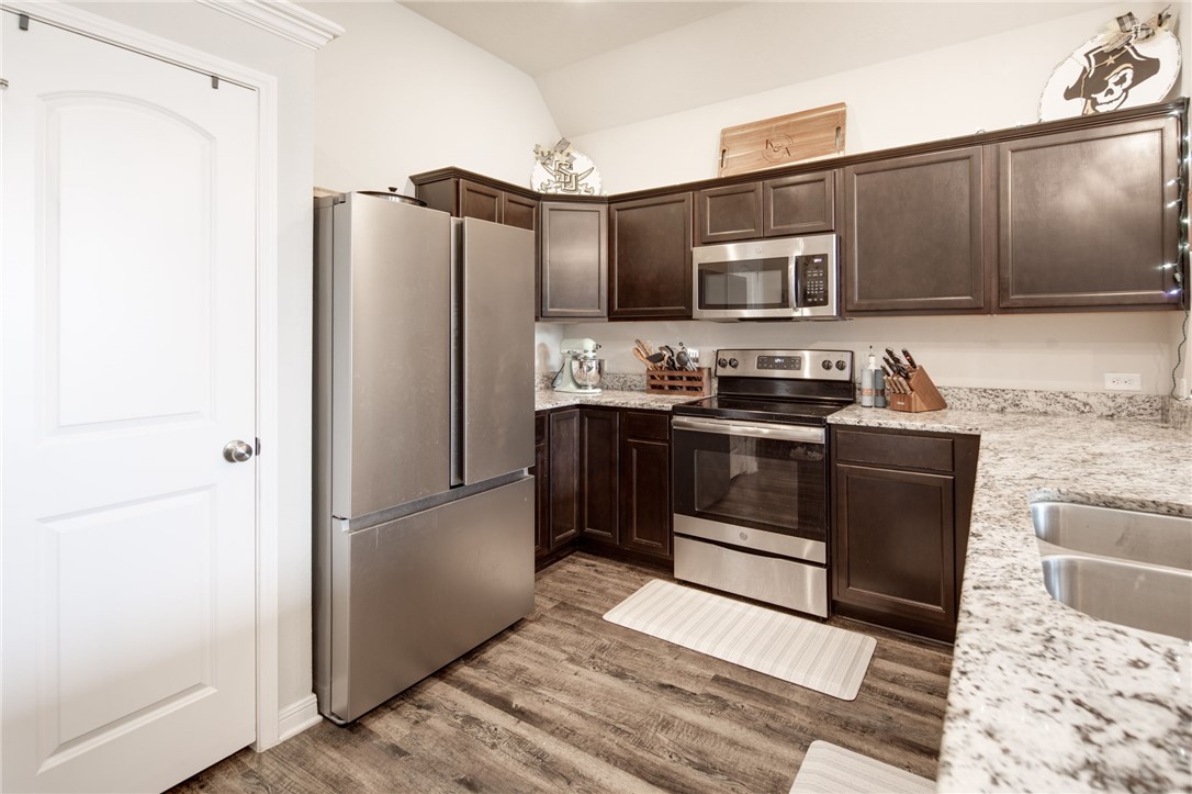 2120 Markley Drive Bryan, TX 77807 - Photo 8 of 21 a kitchen with stainless steel appliances granite countertop a refrigerator and a sink
