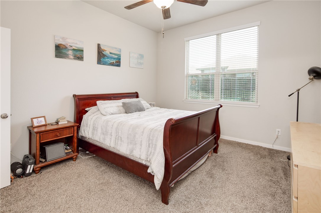 2120 Markley Drive Bryan, TX 77807 - Photo 10 of 21 a bedroom with a bed and a chandelier