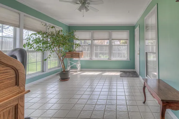 a view of empty room with a large window and dining space