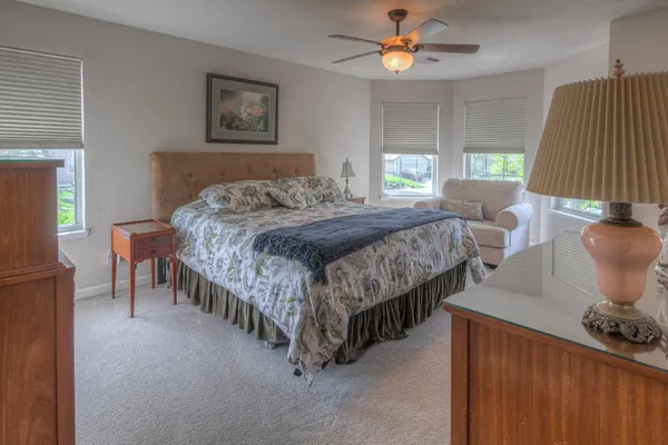 a bedroom with a bed and a window