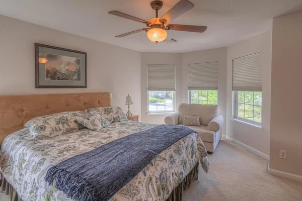 a bedroom with a bed and a window