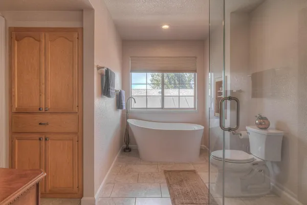 a bathroom with a toilet and shower