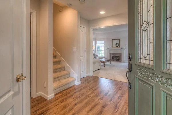 a view of a hallway with wooden floor and staircase