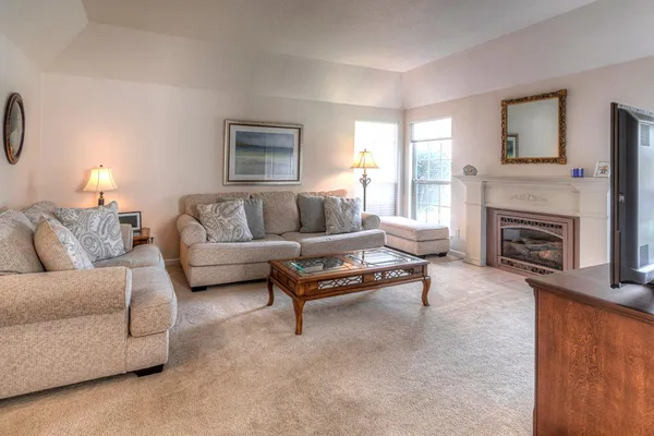 a living room with furniture and a fireplace
