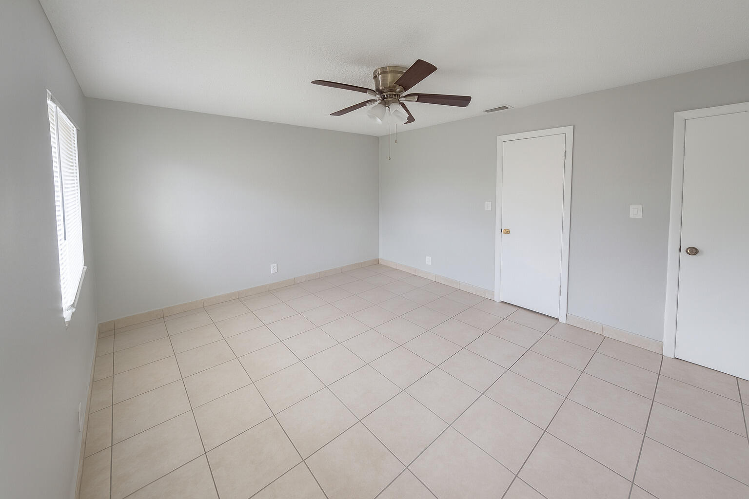 2767 Northwest 58th Terrace Lauderhill, FL 33313 - Photo 5 of 8 a view of an empty room and chandelier fan