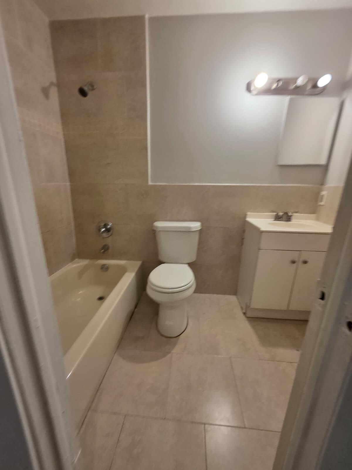 2767 Northwest 58th Terrace Lauderhill, FL 33313 - Photo 6 of 8 a bathroom with a sink a toilet and shower