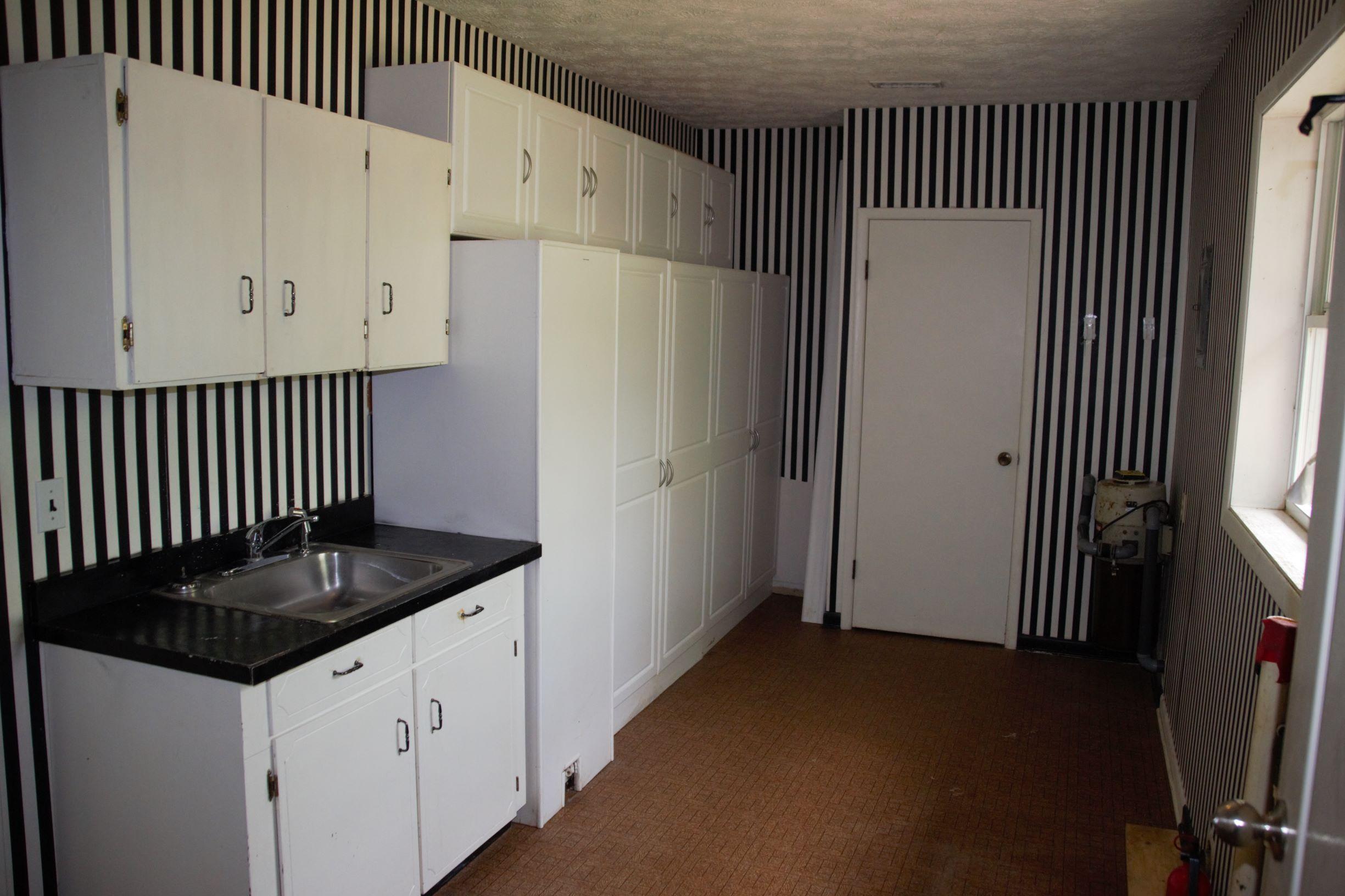 2222 Joy Road Chipley, FL 32428 - Photo 14 of 42 a kitchen with granite countertop cabinets and refrigerator