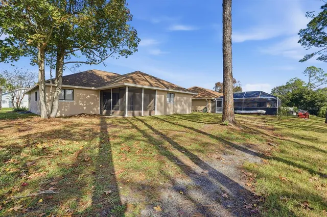 a front view of a house with a garden and trees