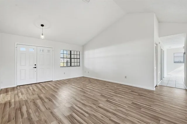 wooden floor in an empty room with a window