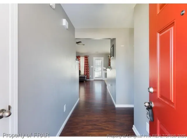 a view of a hallway with wooden floor