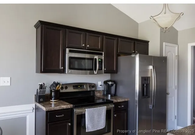 a kitchen with a refrigerator sink and microwave