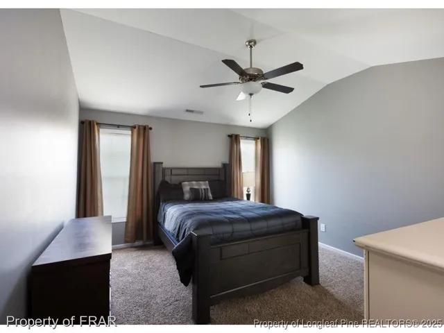 a bedroom with a bed and a mirror