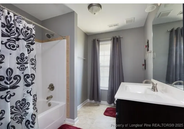 a bathroom with a bathtub and a sink