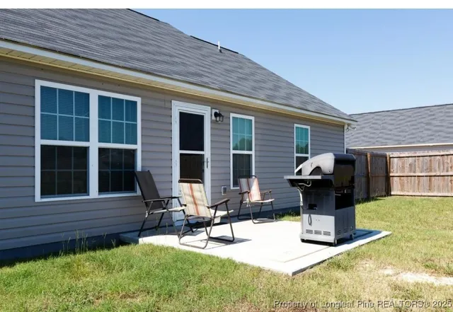 a view of backyard with a table and chairs