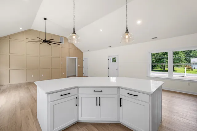 a kitchen with stainless steel appliances a table chairs and cabinets