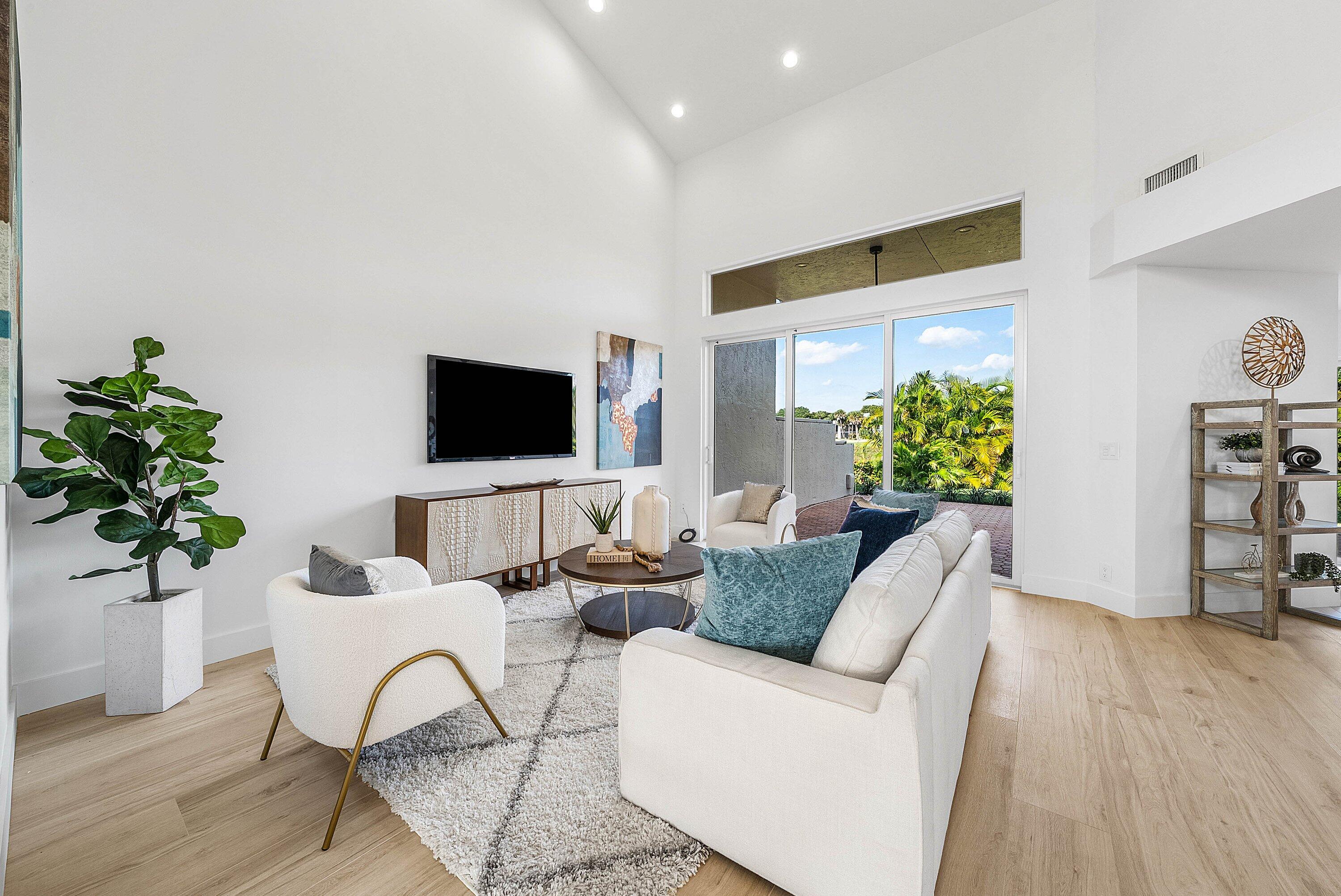5174 Windsor Parke Drive Boca Raton, FL 33496 - Photo 13 of 55 a living room with furniture and a flat screen tv