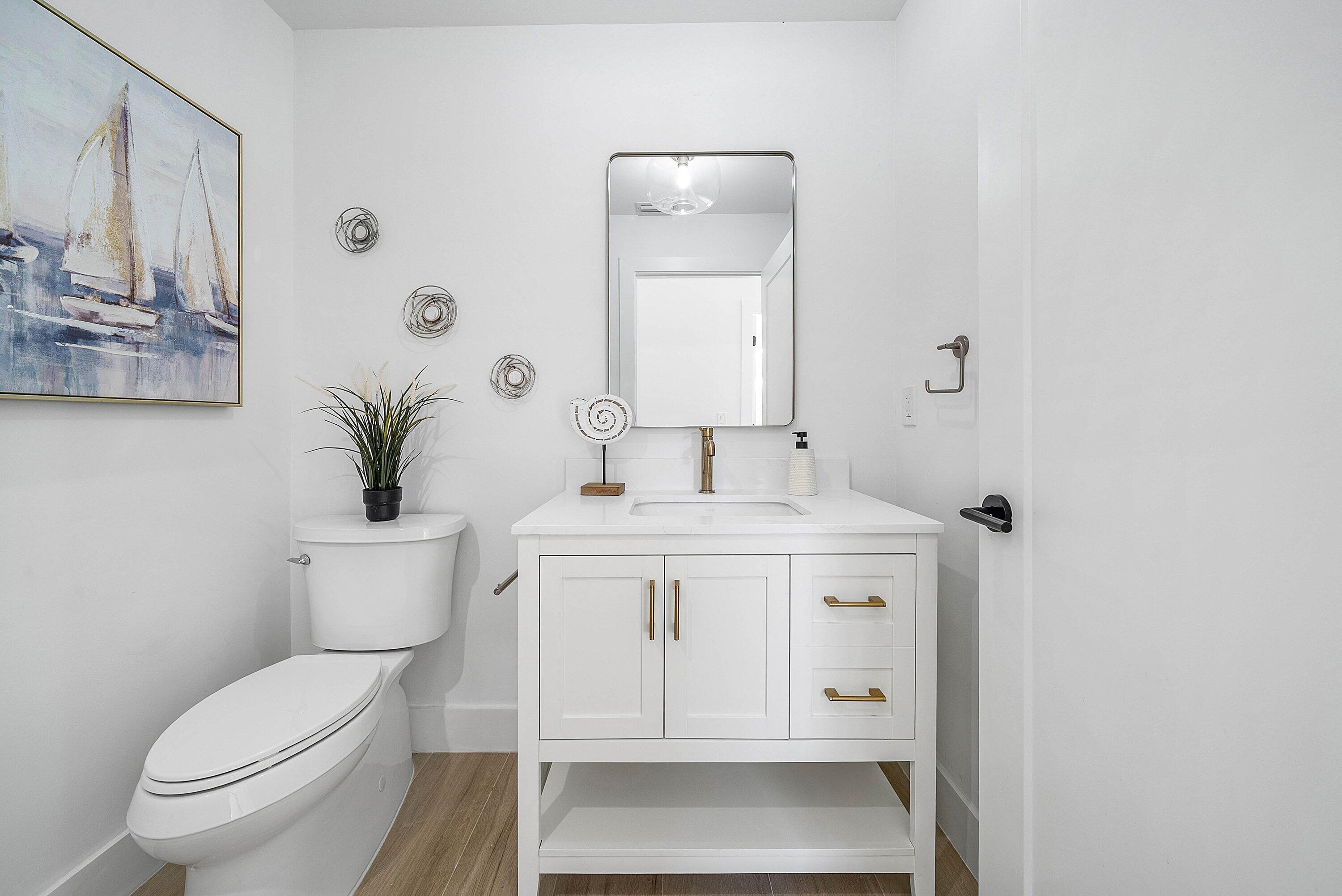 5174 Windsor Parke Drive Boca Raton, FL 33496 - Photo 18 of 55 a bathroom with a sink toilet and vanity