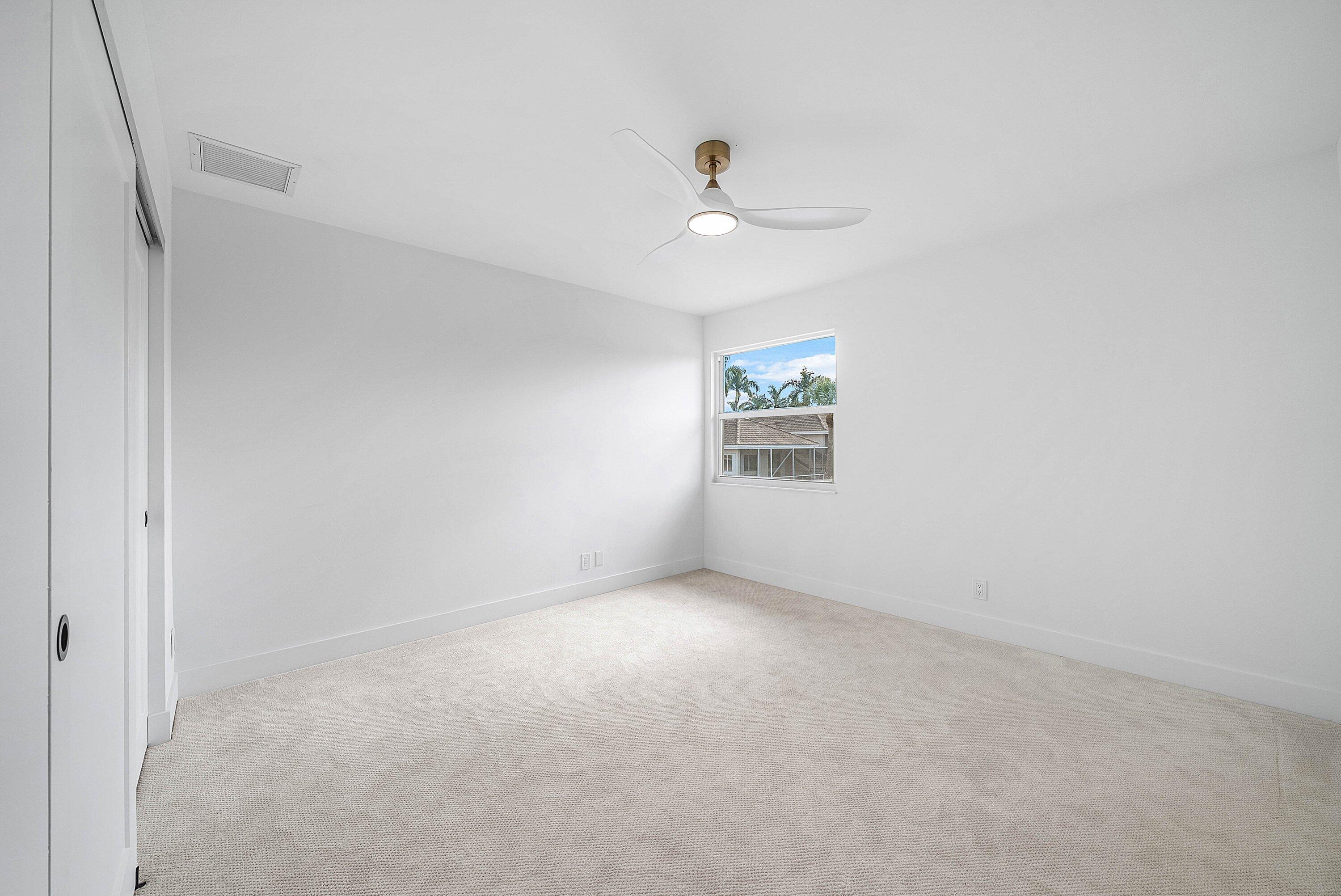5174 Windsor Parke Drive Boca Raton, FL 33496 - Photo 27 of 55 an empty room with a window and ceiling fan