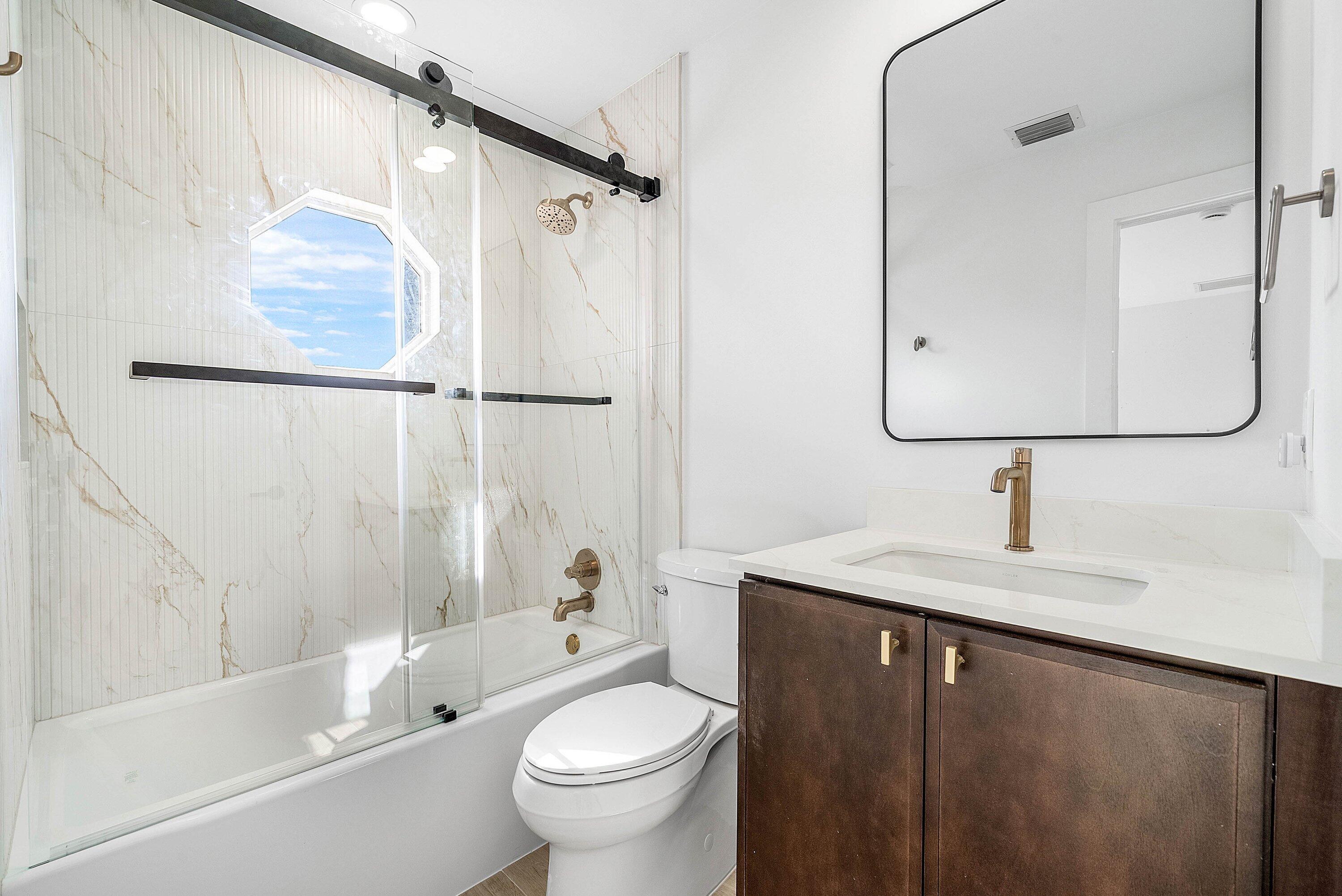5174 Windsor Parke Drive Boca Raton, FL 33496 - Photo 28 of 55 a bathroom with a sink a toilet and shower