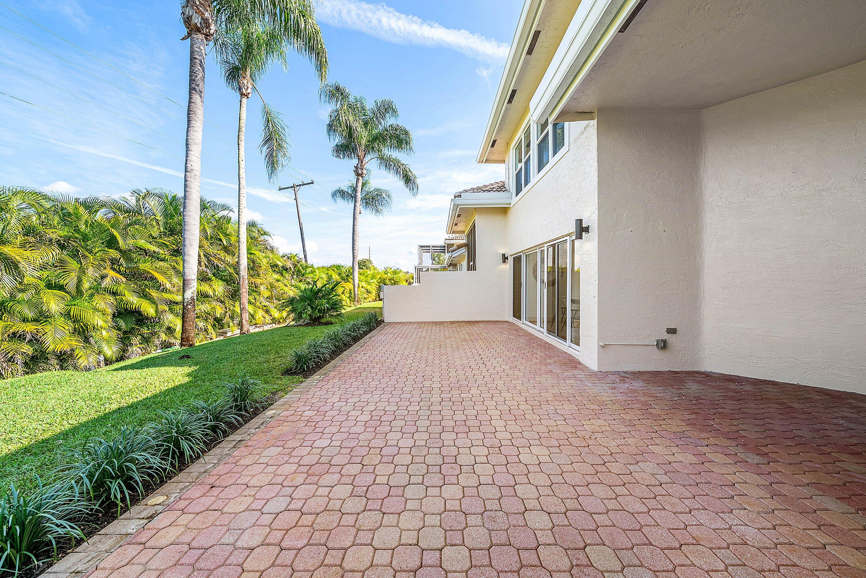 5174 Windsor Parke Drive Boca Raton, FL 33496 - Photo 31 of 55 a view of a house with a yard and a garage