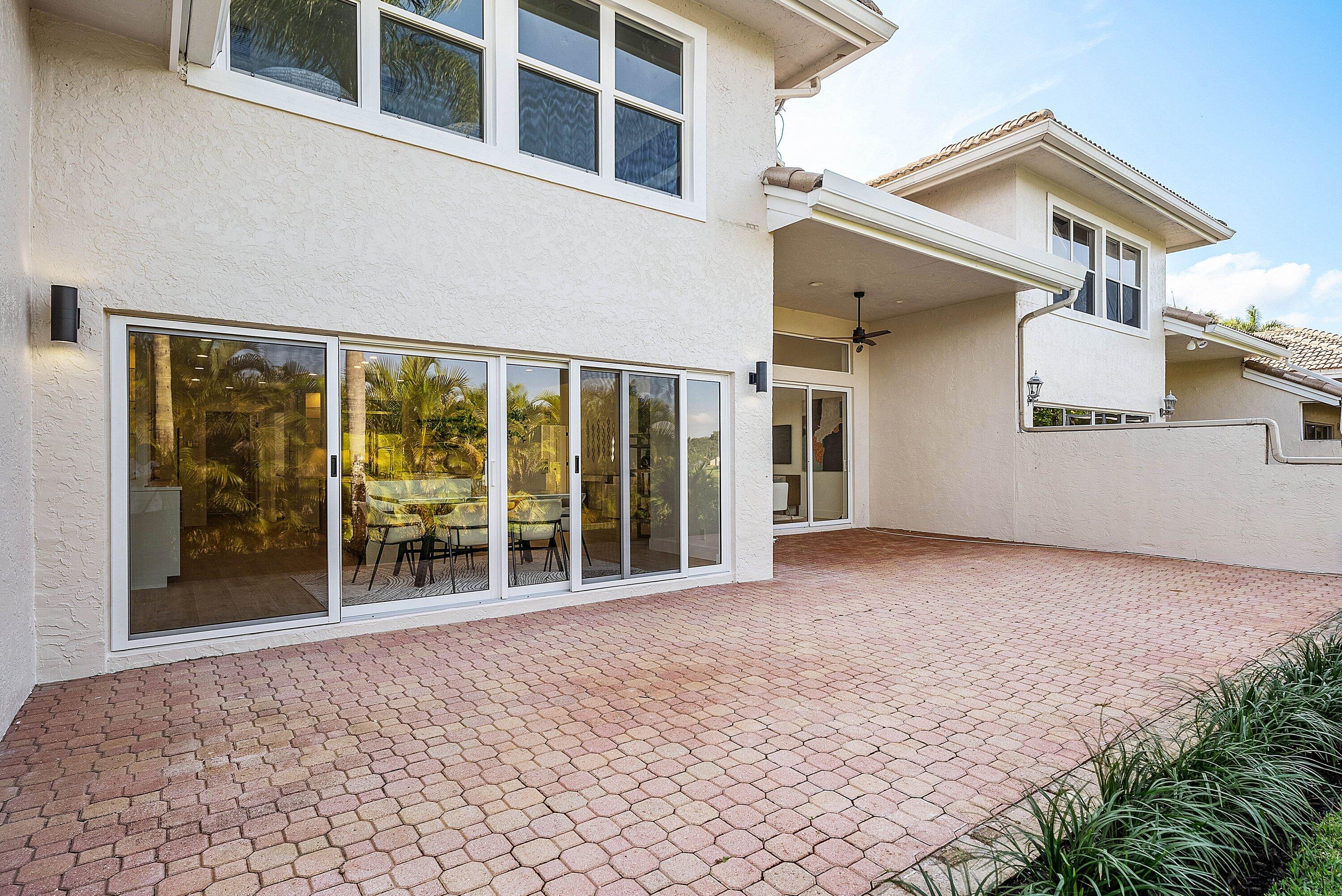 5174 Windsor Parke Drive Boca Raton, FL 33496 - Photo 32 of 55 front view of a house with a large window