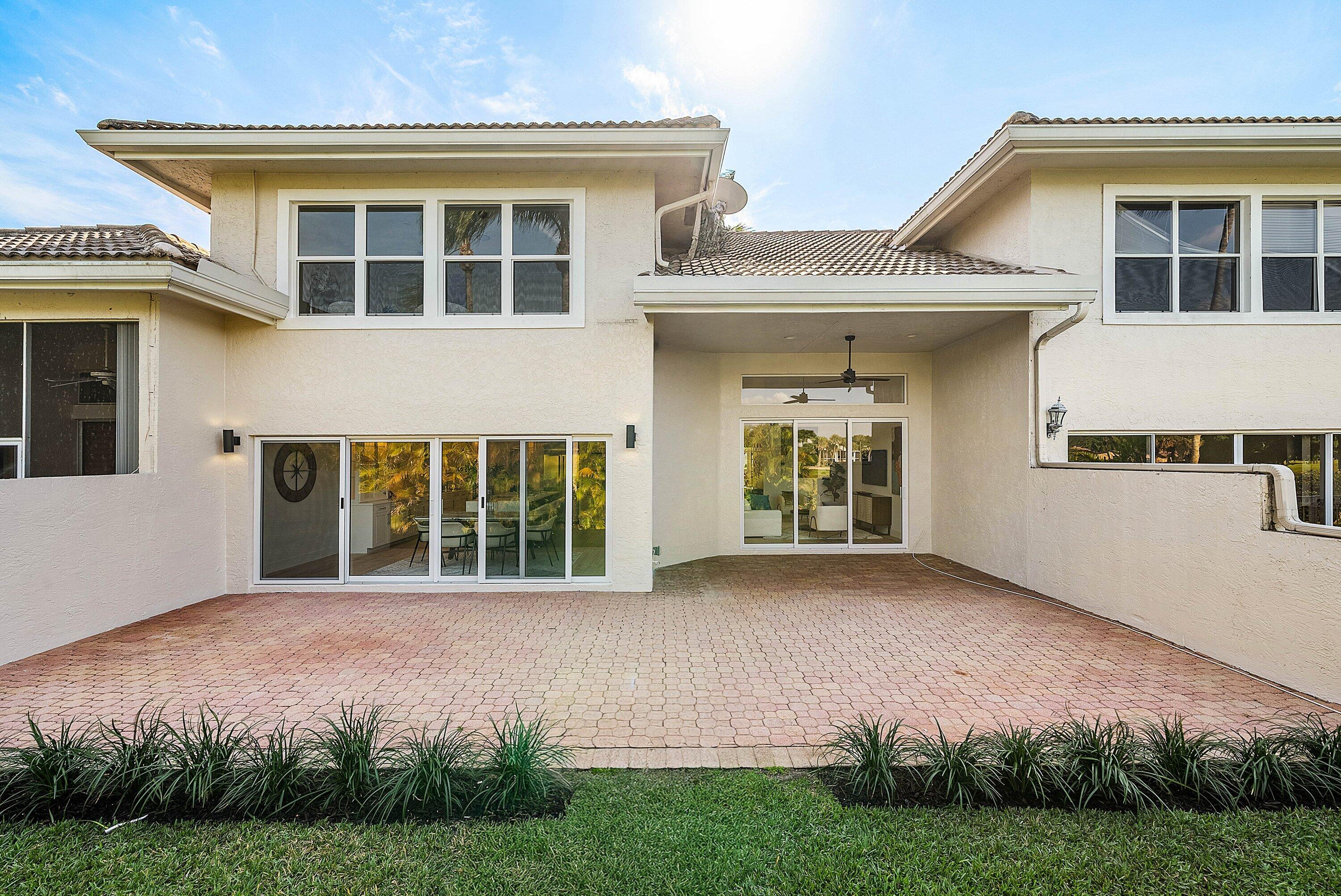 5174 Windsor Parke Drive Boca Raton, FL 33496 - Photo 34 of 55 a front view of a house with yard and green space