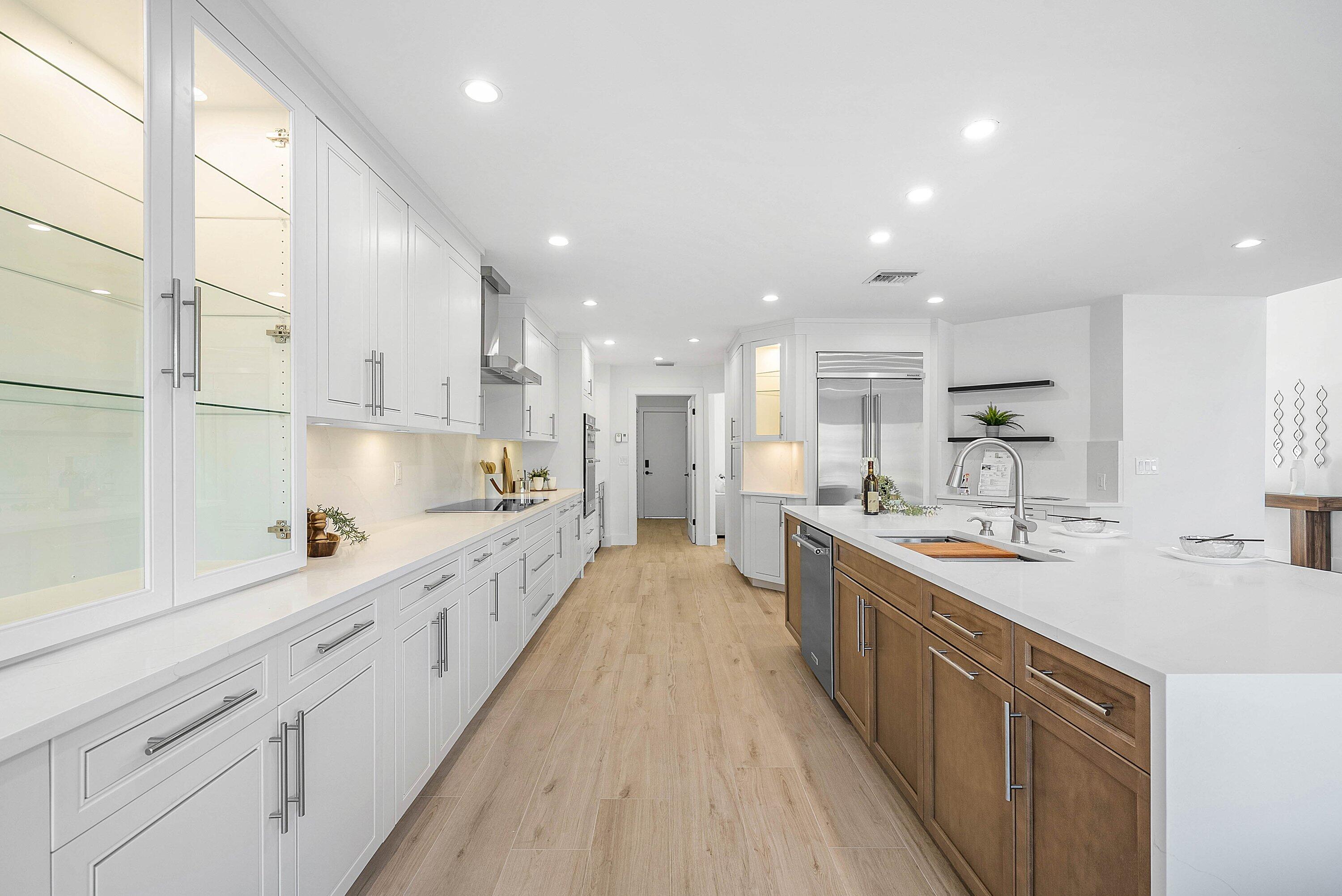 5174 Windsor Parke Drive Boca Raton, FL 33496 - Photo 4 of 55 a large kitchen with stainless steel appliances lots of counter space and wooden floor